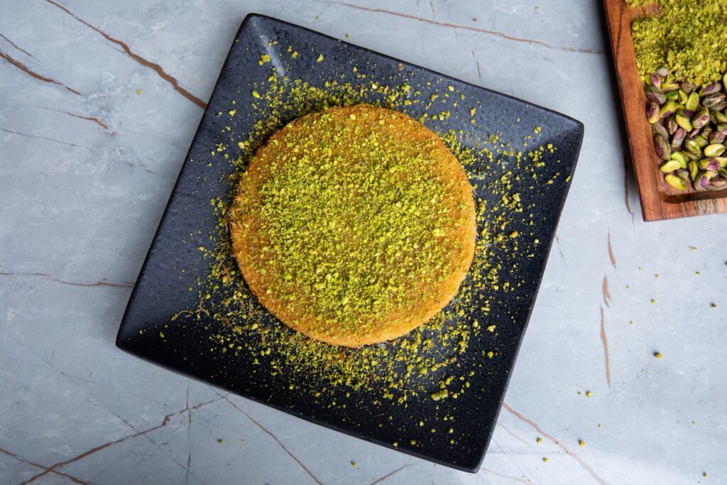 Overhead view of Vavela's kunafa dusted with crushed pistachio